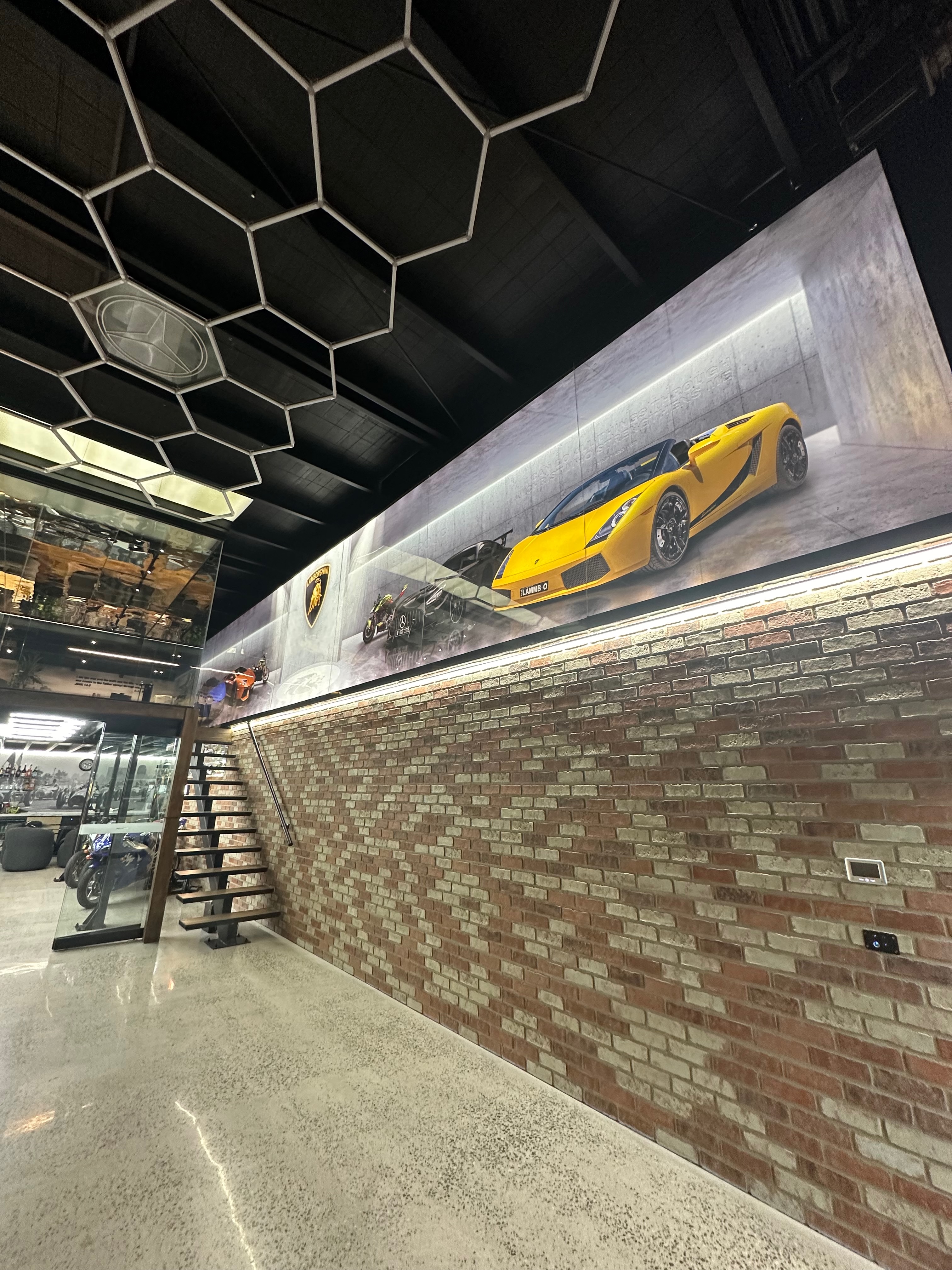 Yellow Lamborghini displayed on illuminated wall shelf